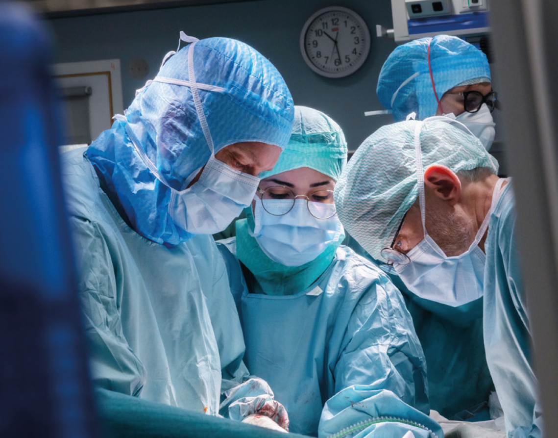 A group of people in ongoing surgery.