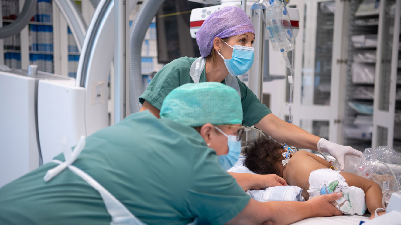 Two doctors treaing a child.