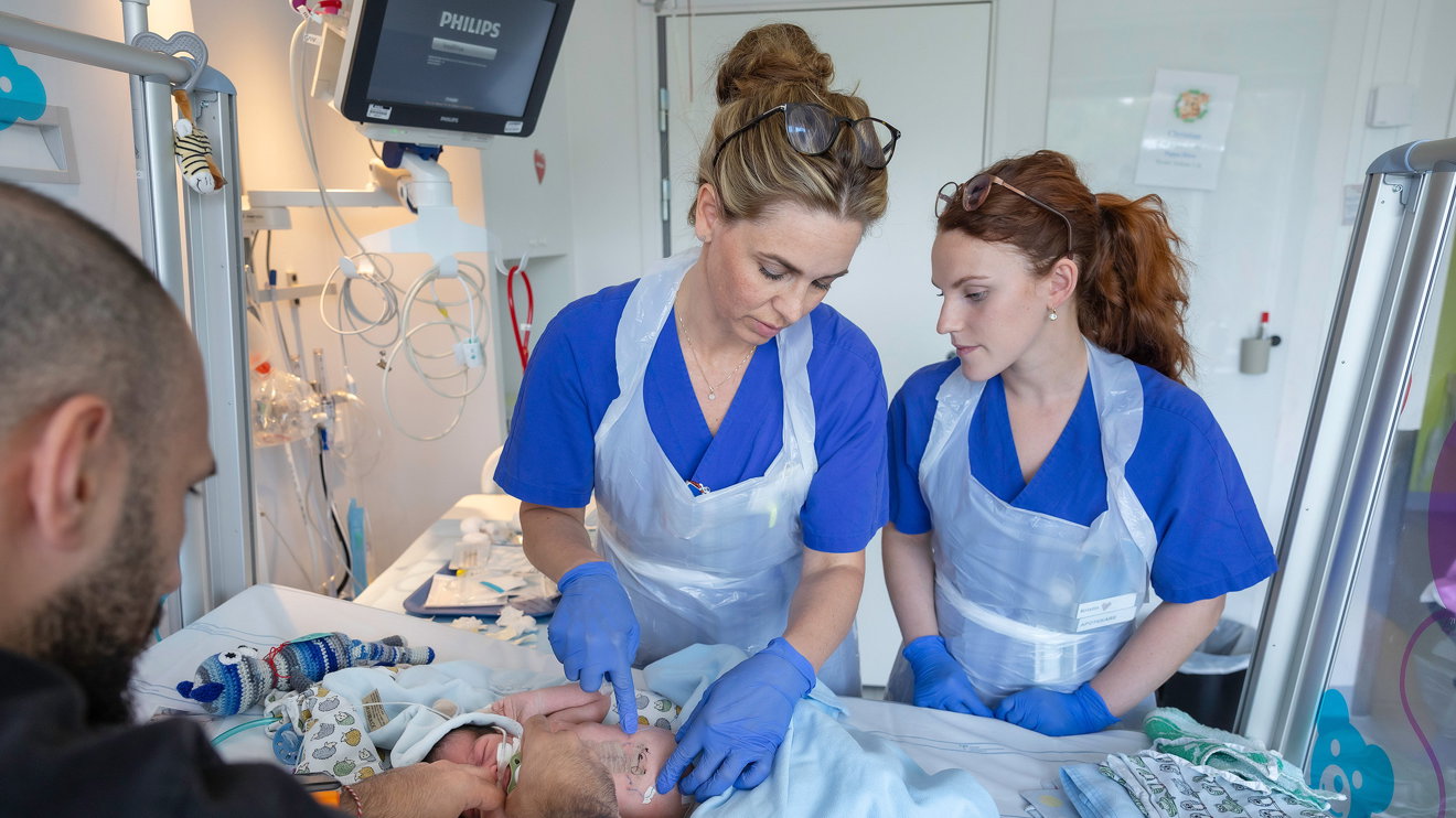 Two doctors caring for a child.