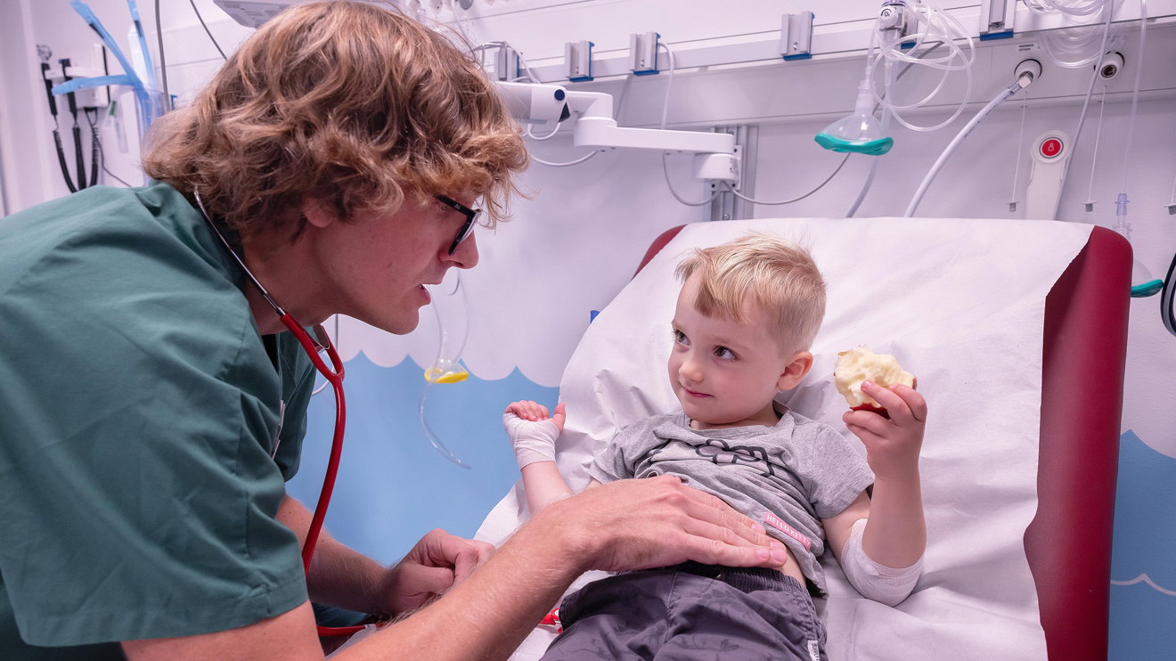 A doctor comforting a child.