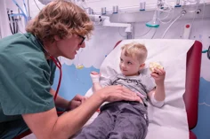 A doctor comforting a child.