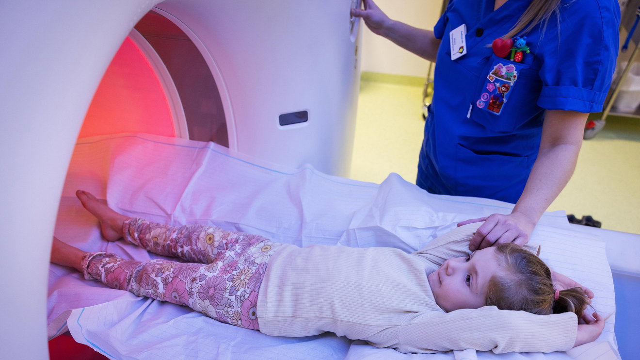 A child being entered into an MRI machine.