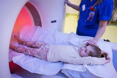 A child being entered into an MRI machine.