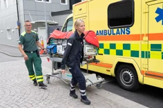 A neonatal child being transported to an ambulance.