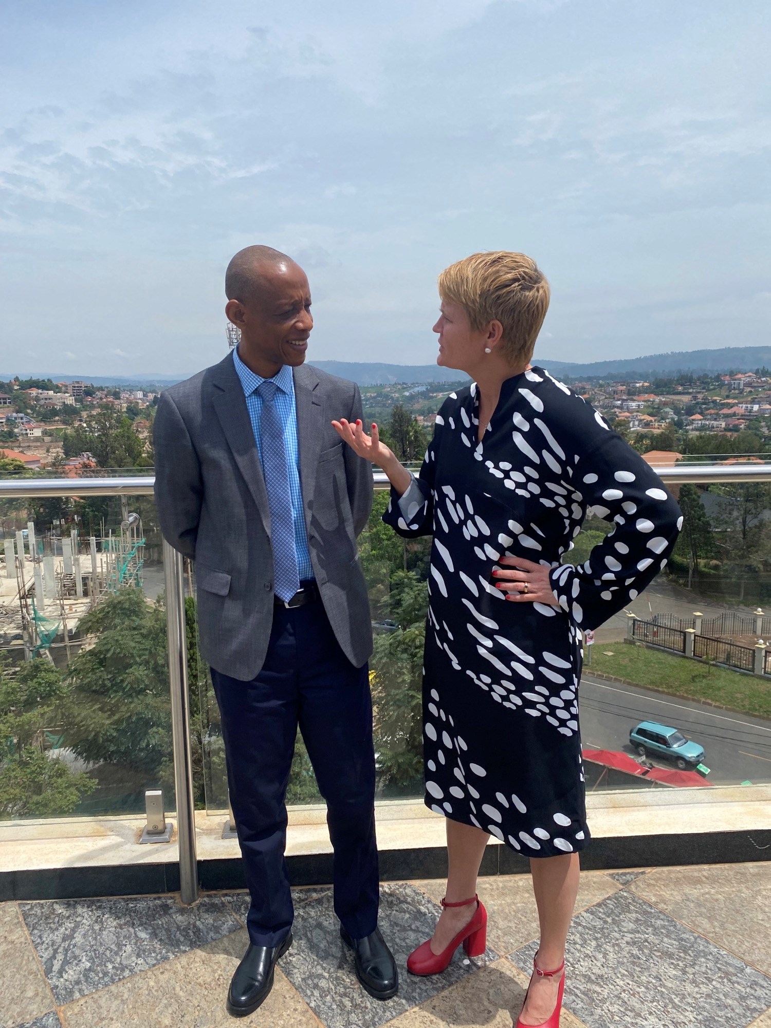Discussion between General director of Food and Drug Administration and Swedish Ambassador in Rwanda with Kigali in the background
