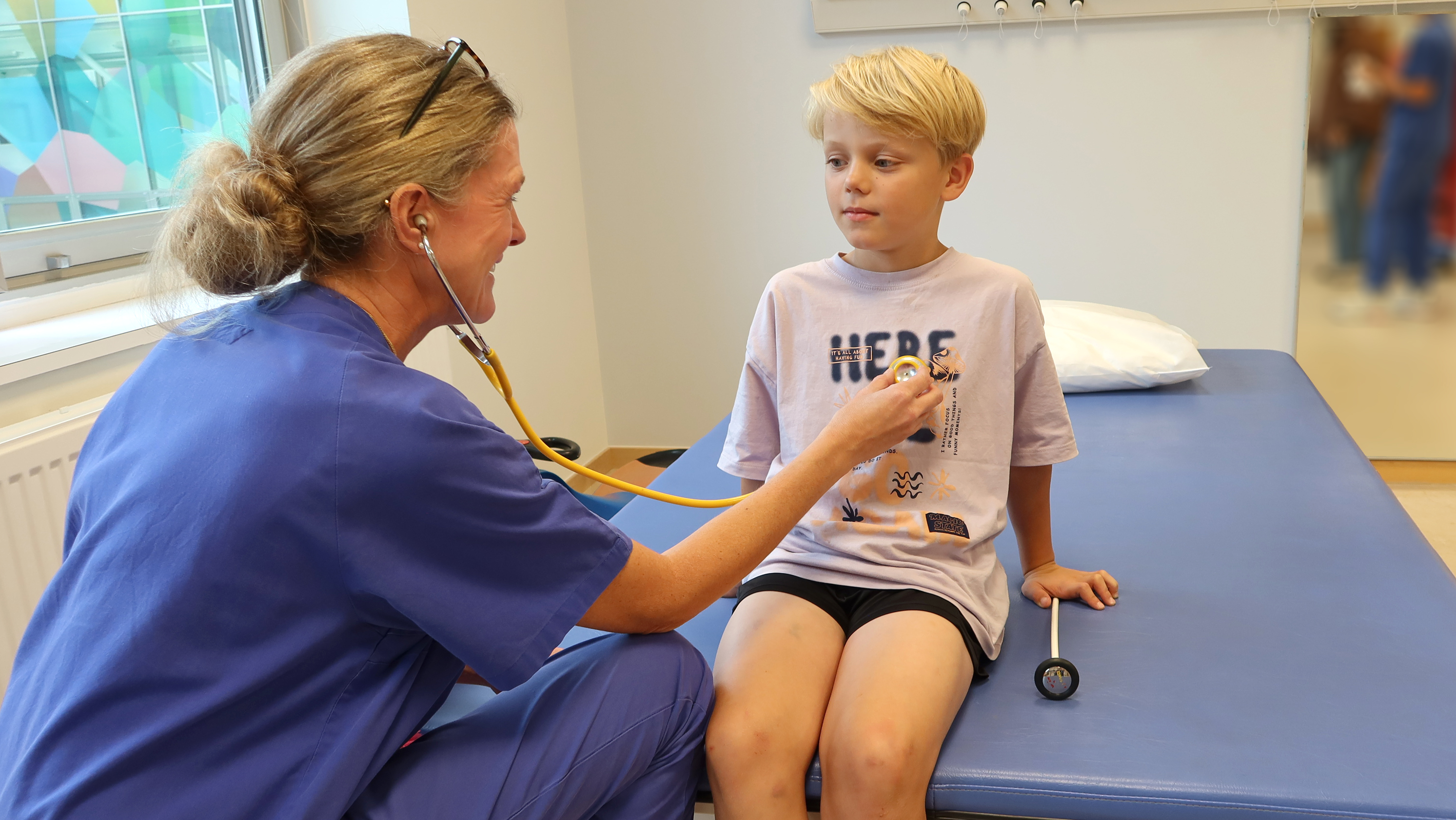 En läkare lyssnar på hjärtat på ett barn