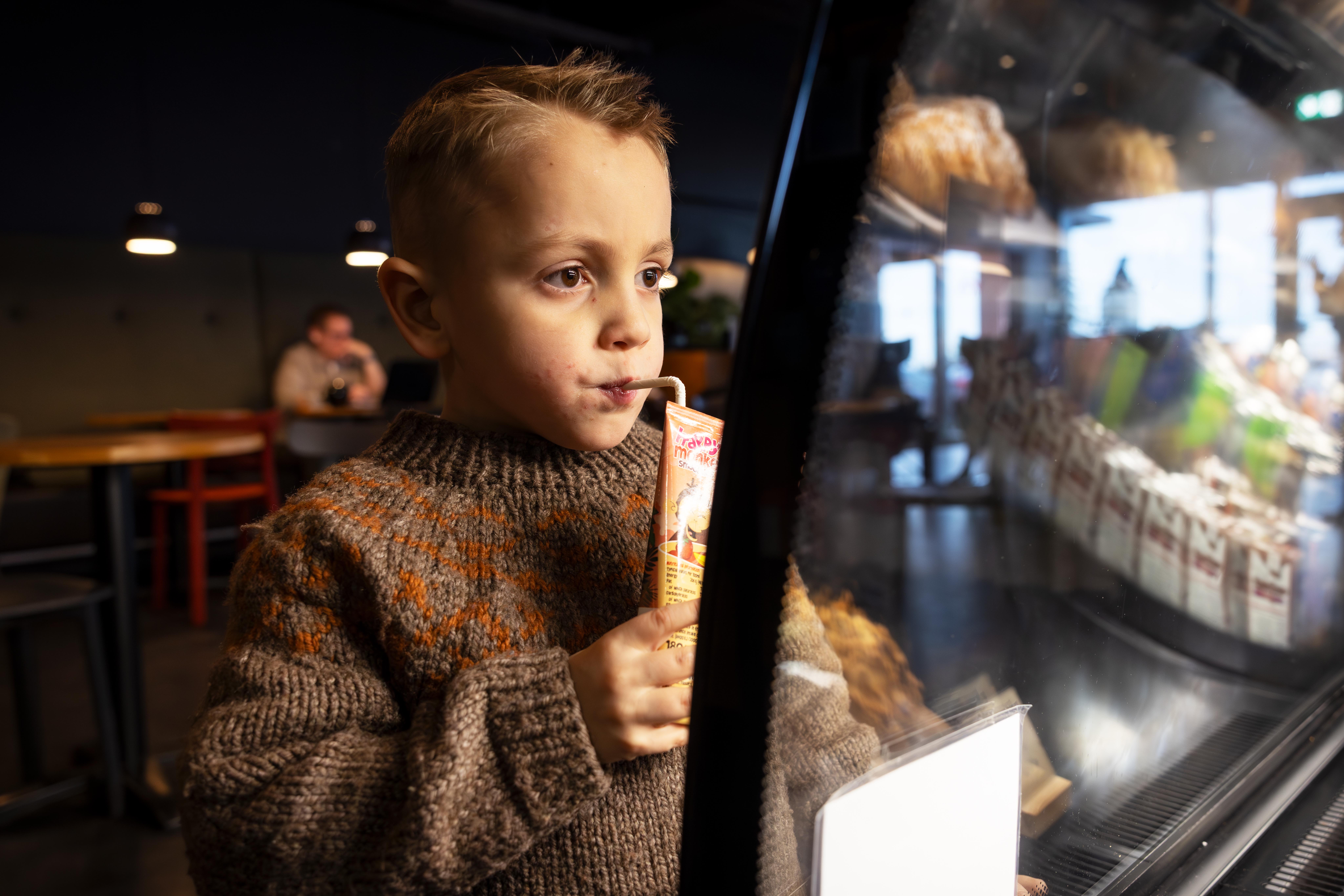 Boy drinking lemonade in a cafeteria