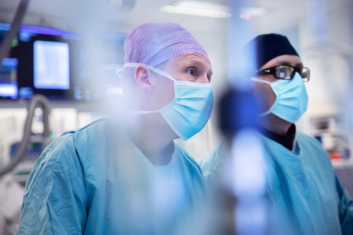 Two doctors in blue scrubs in an operating room