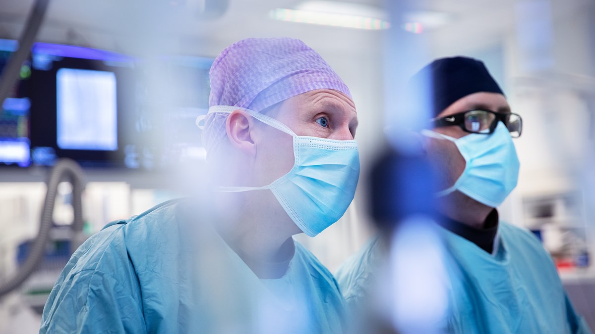Two doctors in blue scrubs in an operating room