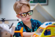 A child playing with an ambulance toy.