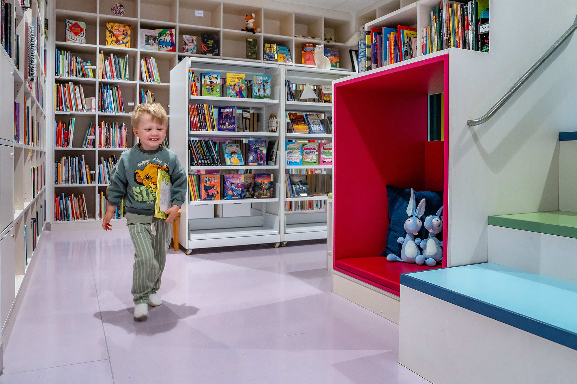 A child running through a childrens library.