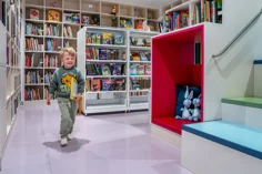 A child running through a childrens library.