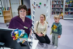 A mother and child with the hopsitals librarian.