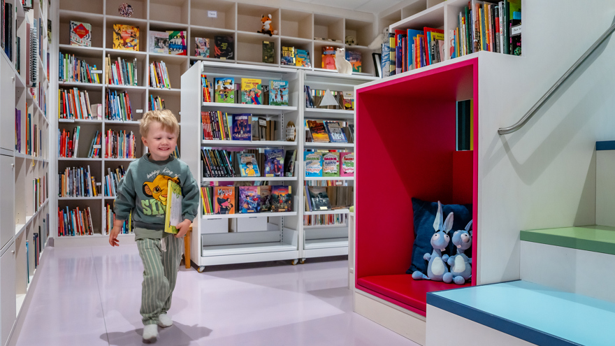 Boy with a book in the library