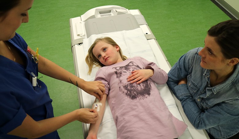 Ett barn får en plastslang i armen