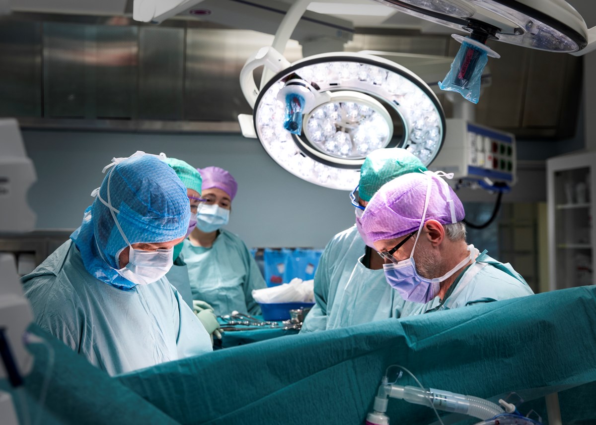 Surgeons in scrubs performing a surgery in an operating room