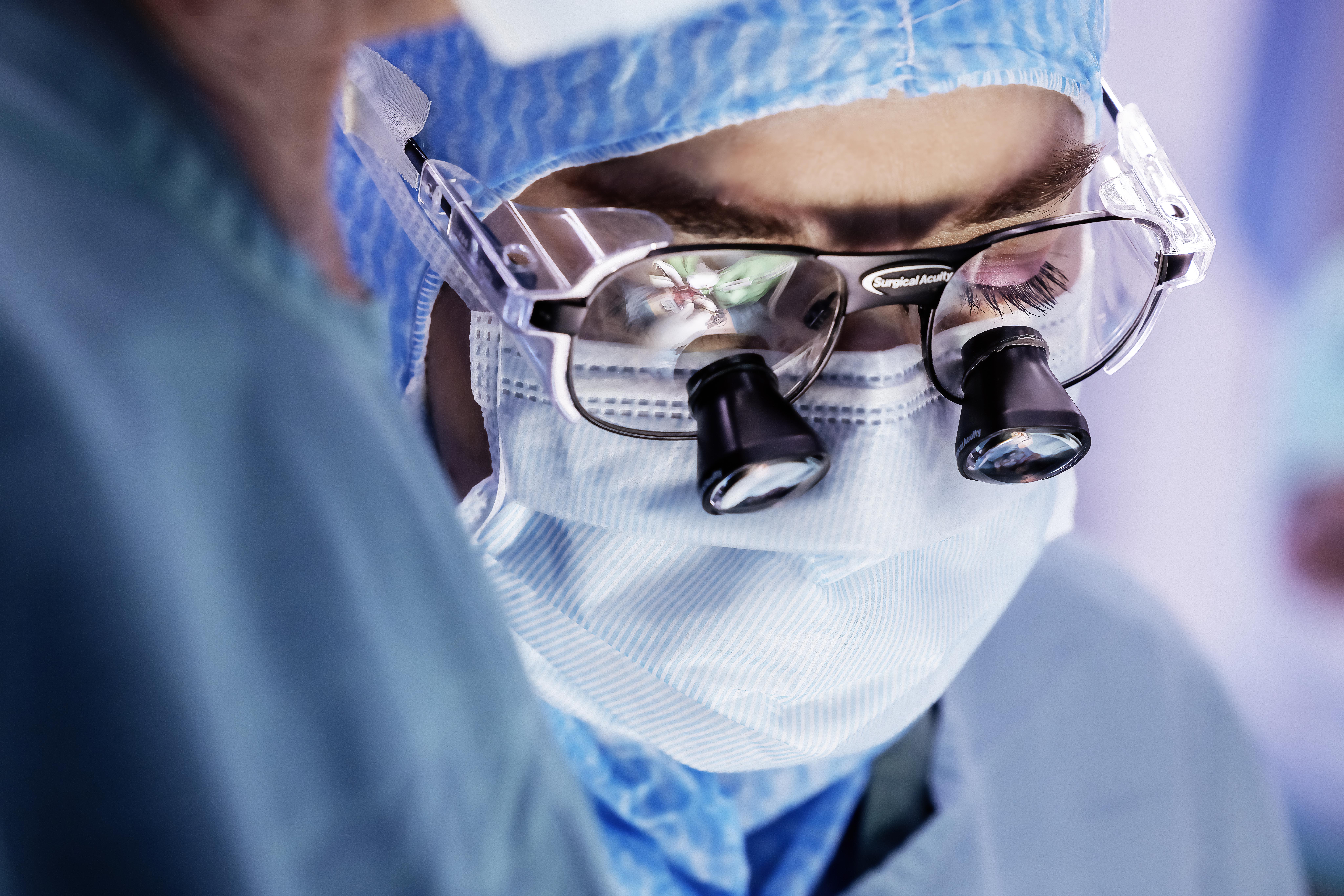 A doctor wearing magnifying glasses.